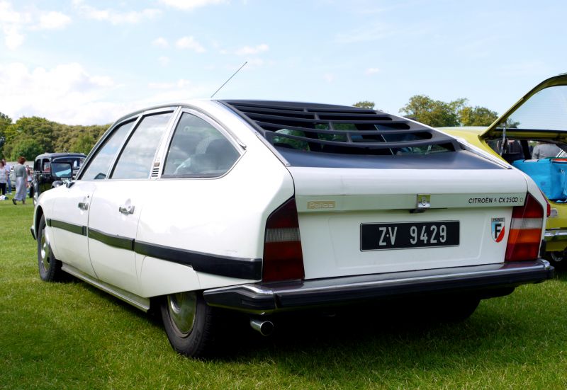 Rear hatchback view with distinctive rear window louvers and aerodynamic shape.
