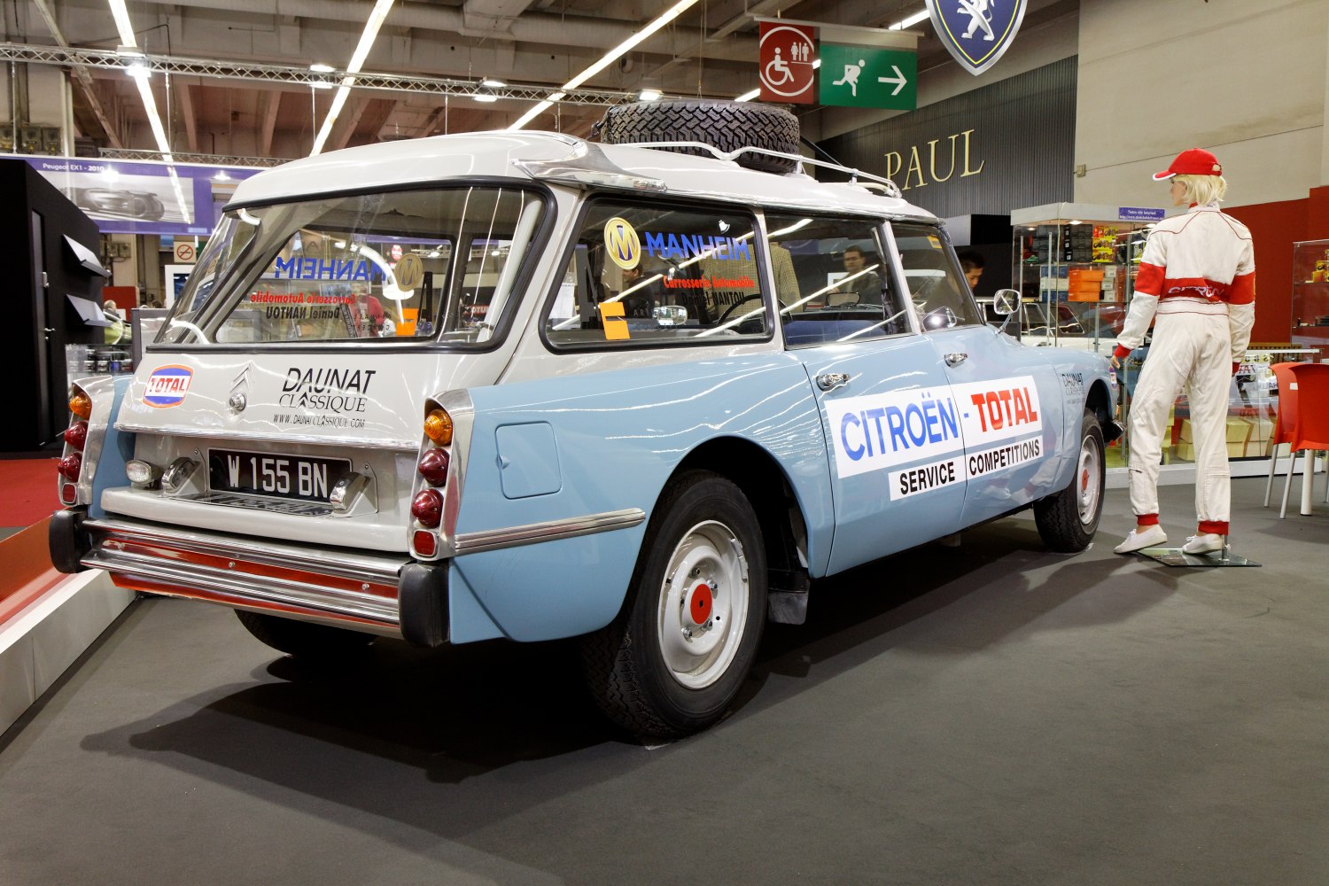 Vintage station wagon with roof spare tire and rally service stickers