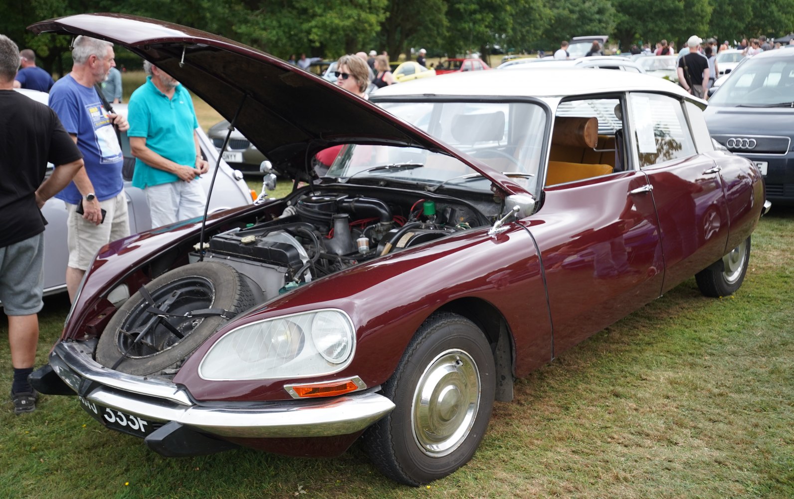 Open hood showing spare tire and front engine layout of vintage vehicle