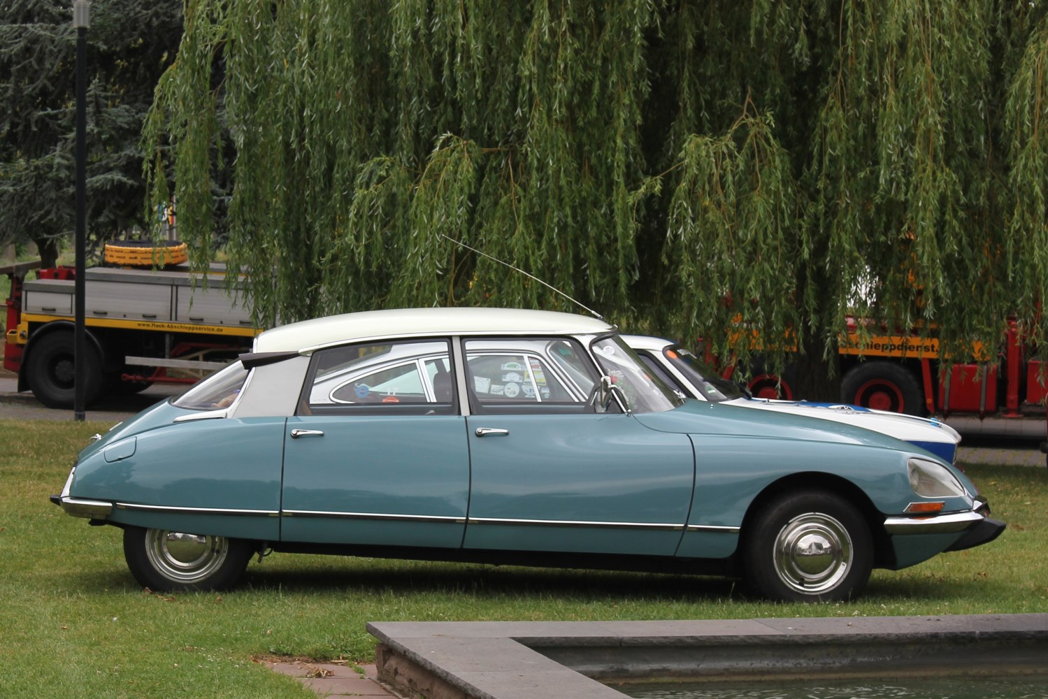 Vintage car with streamlined body and curved rear roofline.
