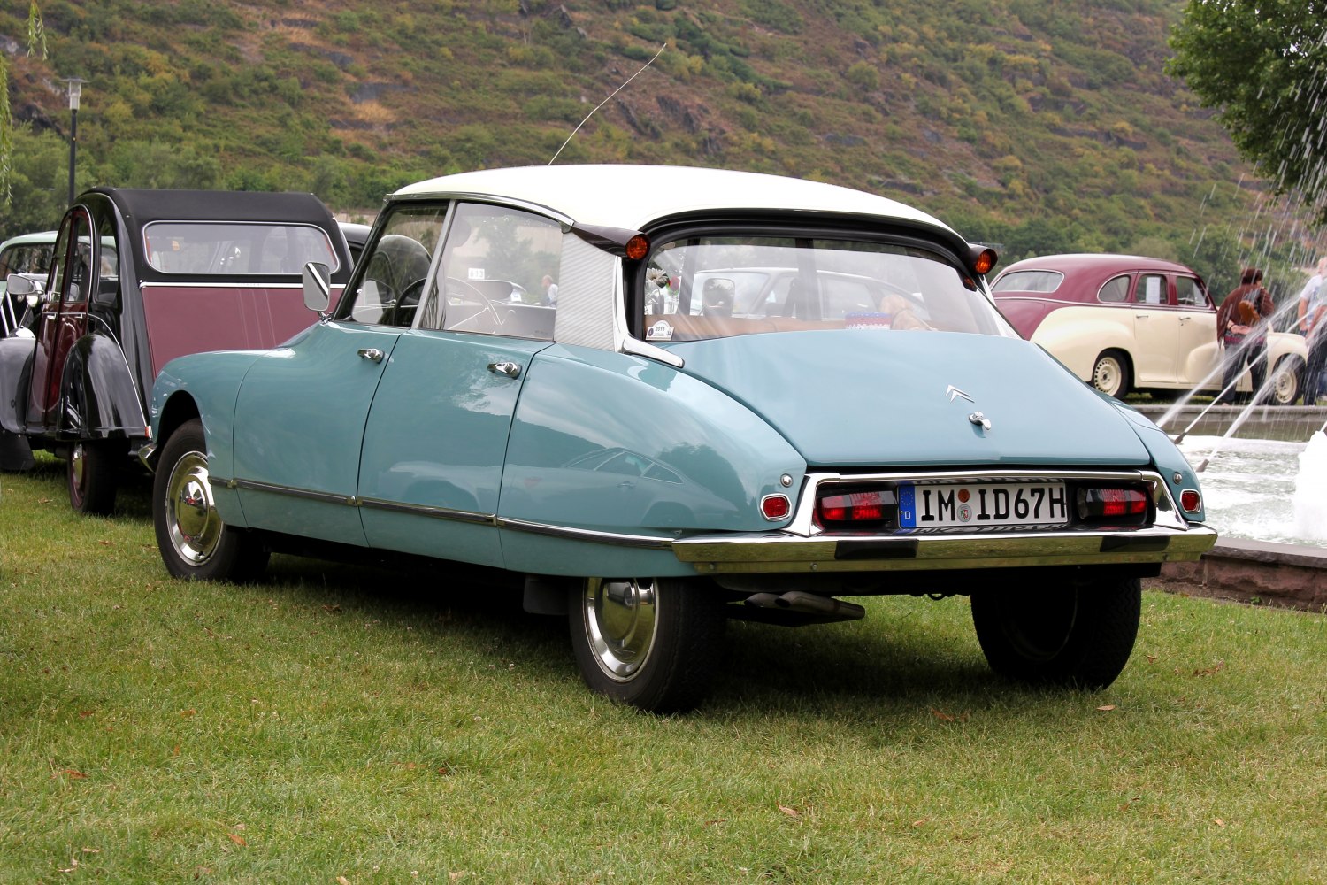 Rear view of classic 1960s sedan with unique tail lights and curved roofline.