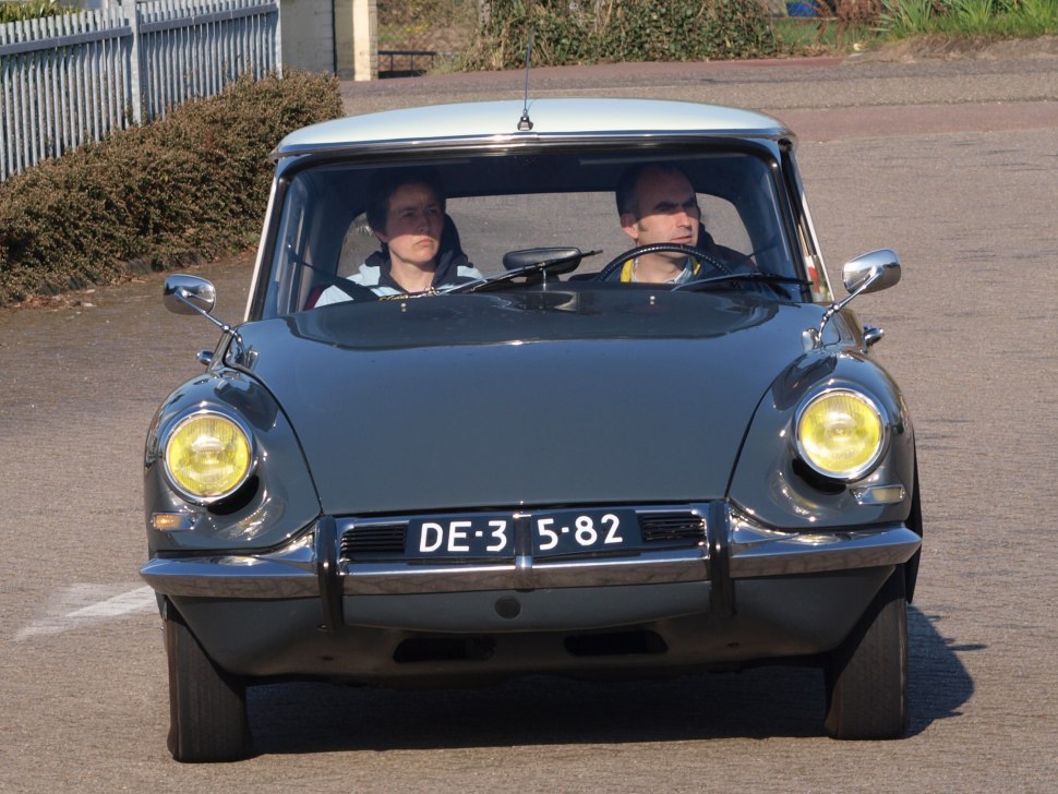 Front view of vintage classic car with yellow headlights and chrome bumper