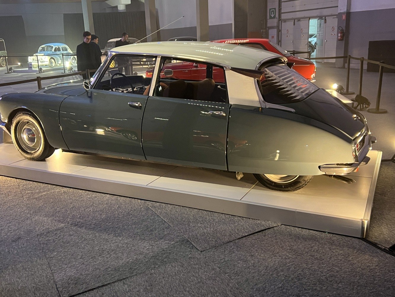 Vintage vehicle with distinctive rear window louvers and sleek, curved body profile