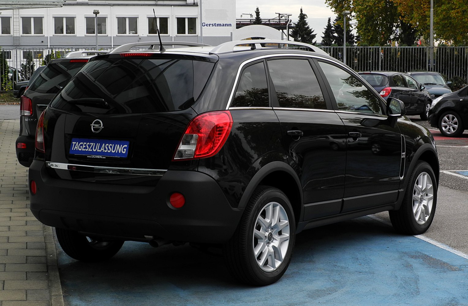 Rear and side view of compact SUV with roof rails and alloy wheels