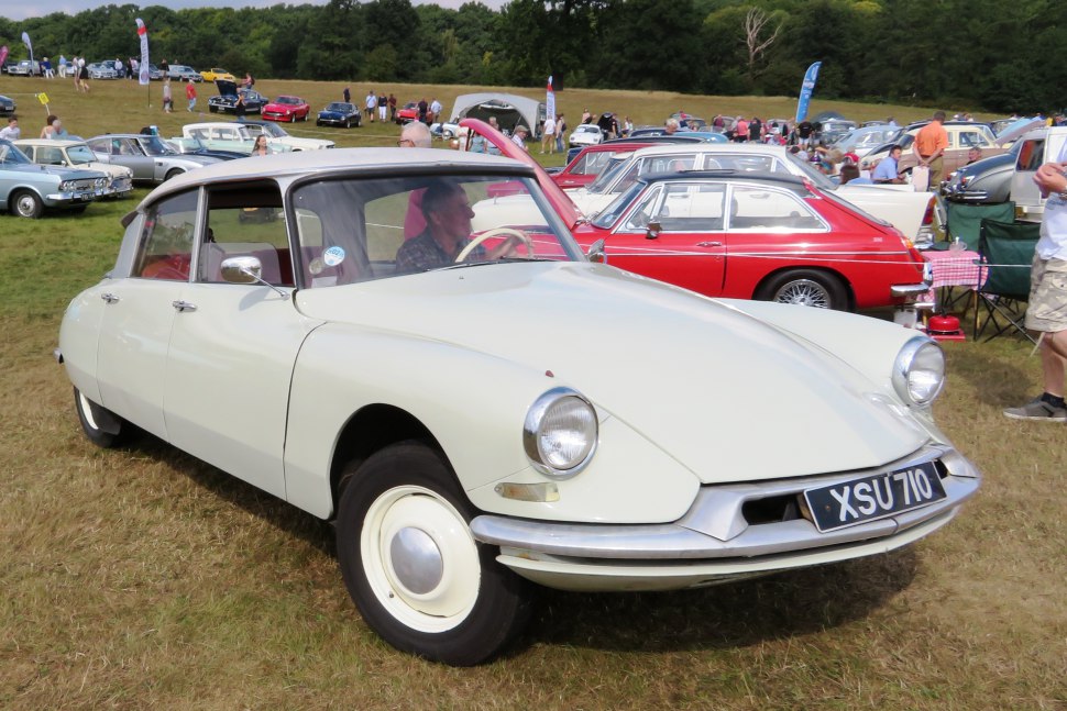 Classic vintage car with round headlights and chrome bumper.