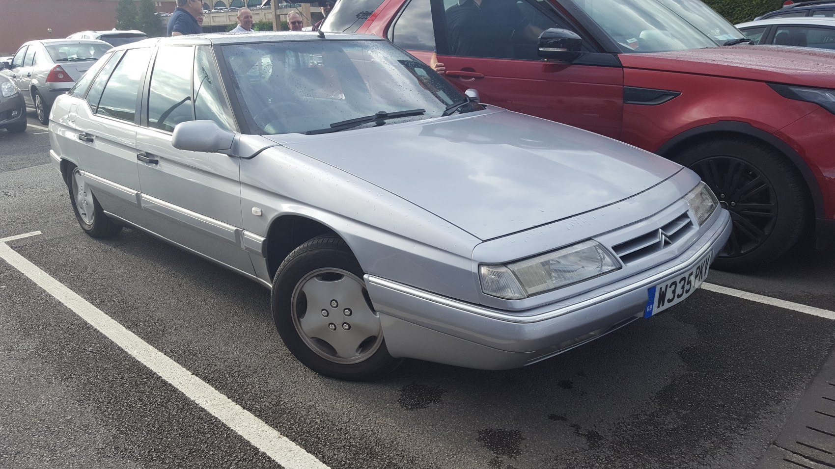 Silver sedan with angular front and OEM alloy wheels