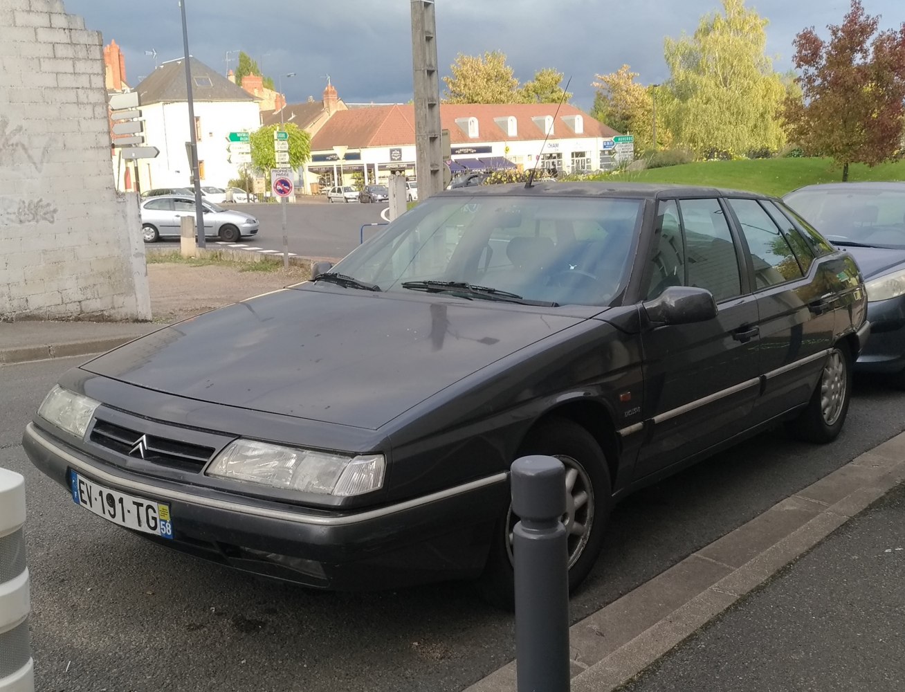 Front-side angle of a 1990s angular sedan with classic headlights