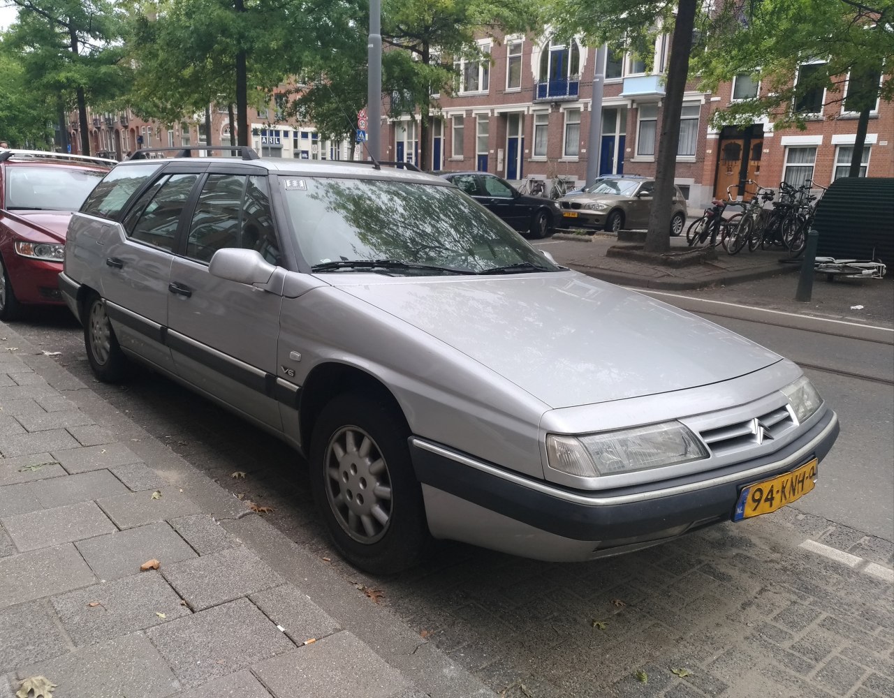 Silver station wagon with front and side view parked on street