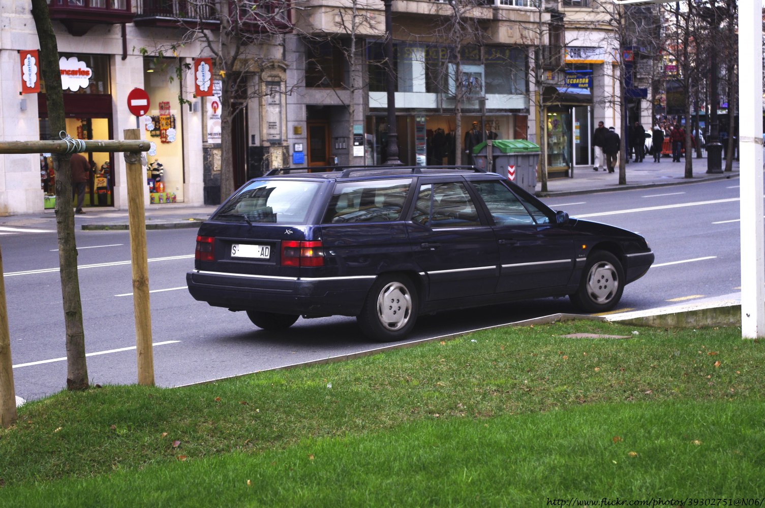 Rear and side view of a 1995 station wagon in a city street
