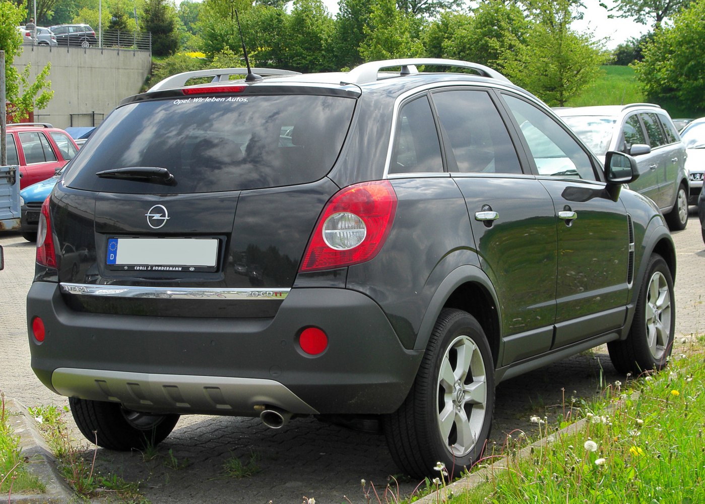 SUV rear view with tail lights and roof rails