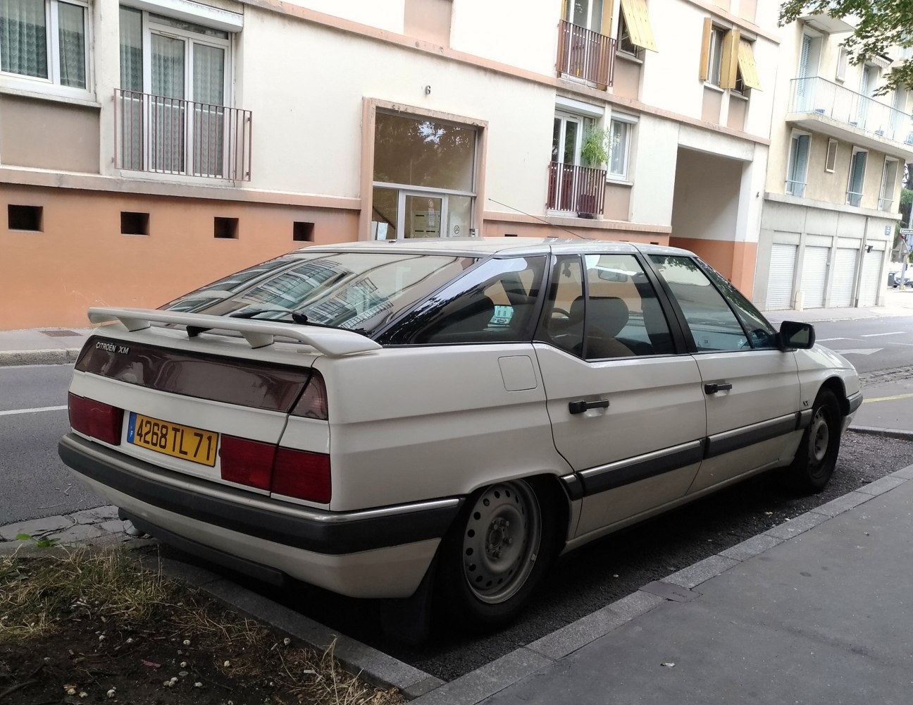 Rear side view of a classic sedan with spoiler and angular rear design