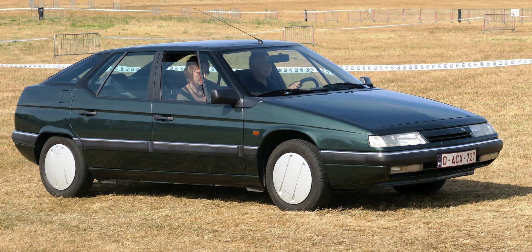 Aerodynamic wedge-shaped car with flush headlights and smooth body lines