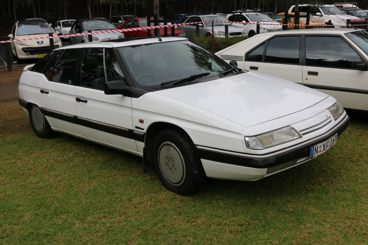 White 1990s sedan with sharp angular design and aerodynamic shape