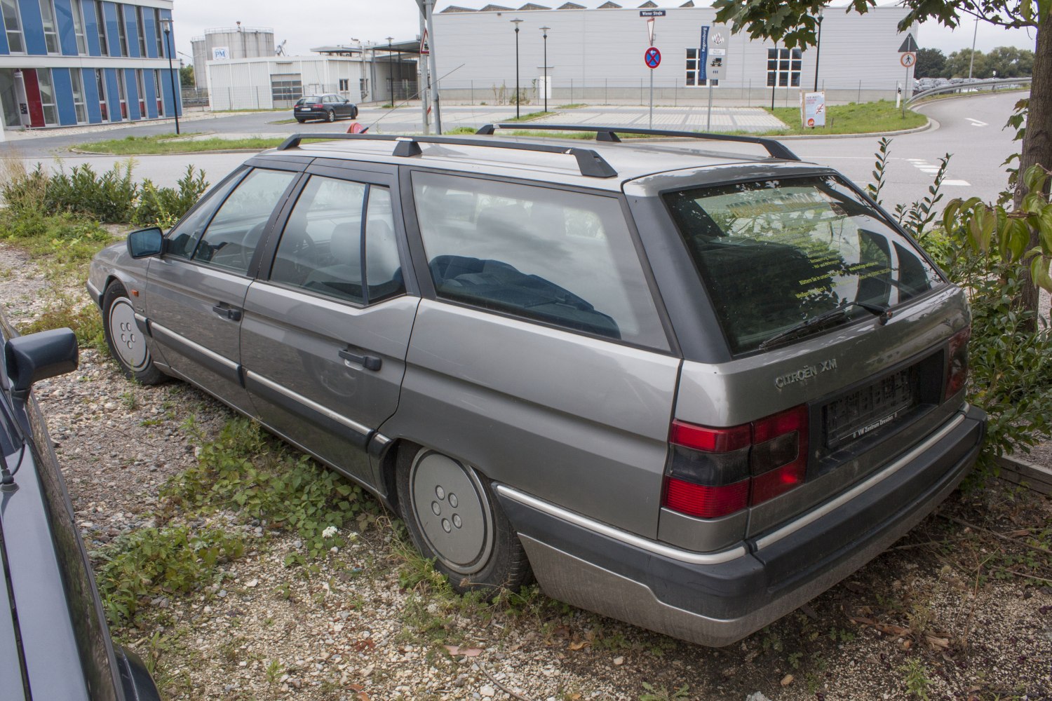 Classic early 90s station wagon with roof rails and rear spoiler