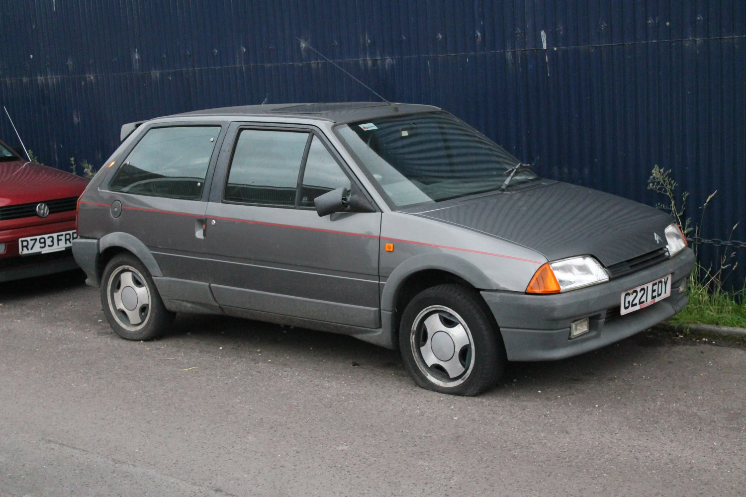 Side profile of vintage 1980s compact hatchback with visible wheels and door lines
