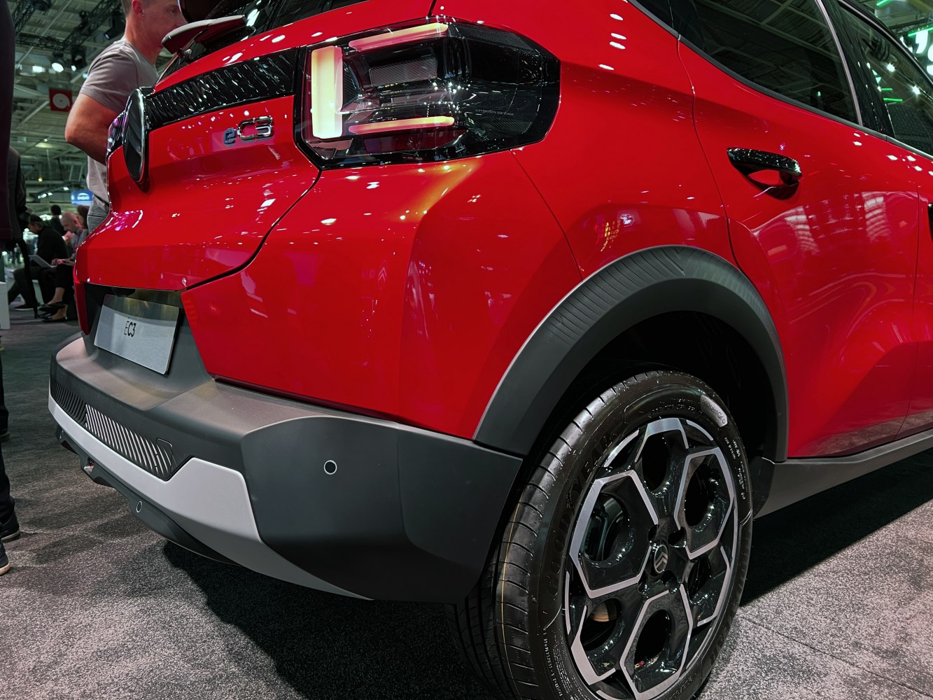 Rear taillight design and alloy wheel close-up on a red hatchback