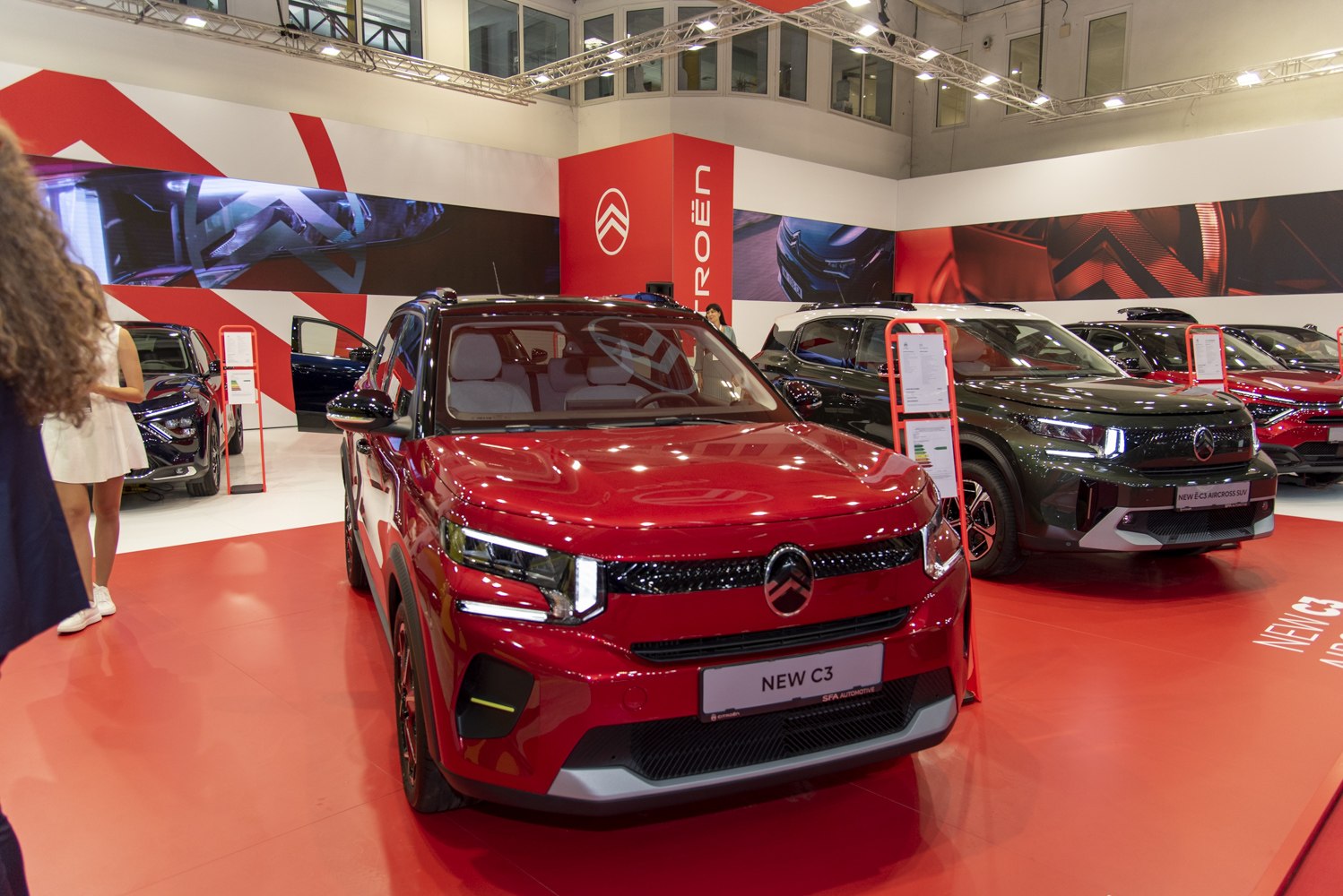 Front view of a red compact SUV with modern LED headlights and bold grille