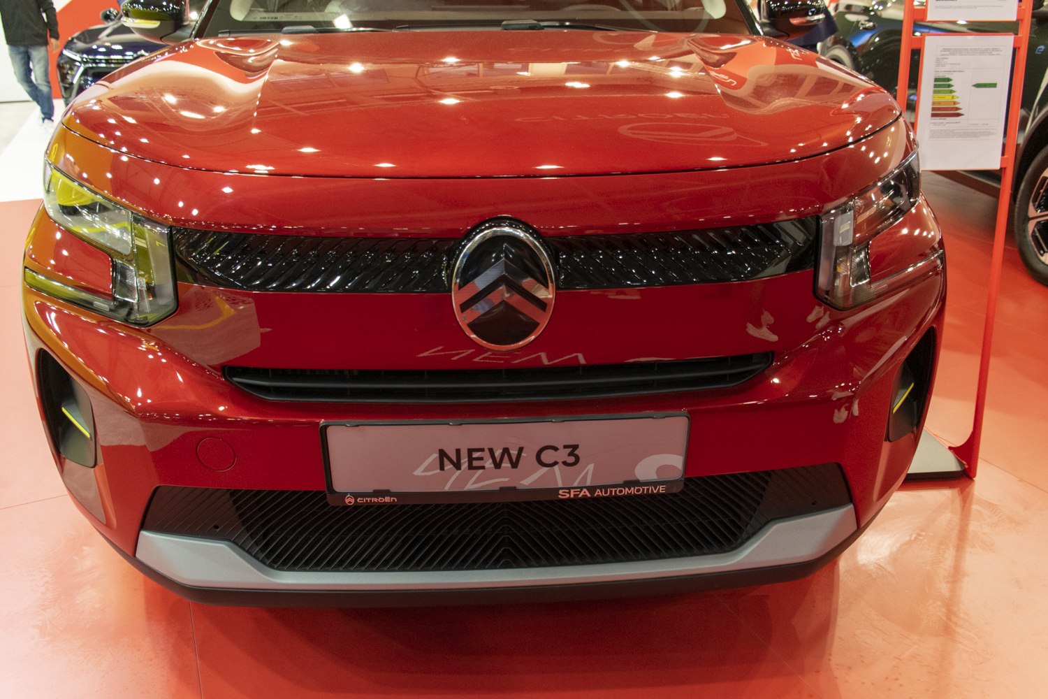 Close-up on front grille and headlights of a modern car.