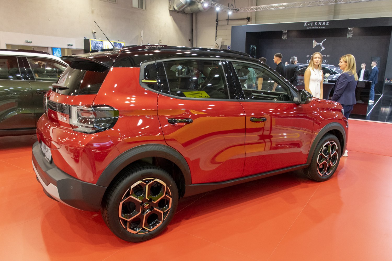 Red compact SUV with two-tone black roof and distinct alloy wheels