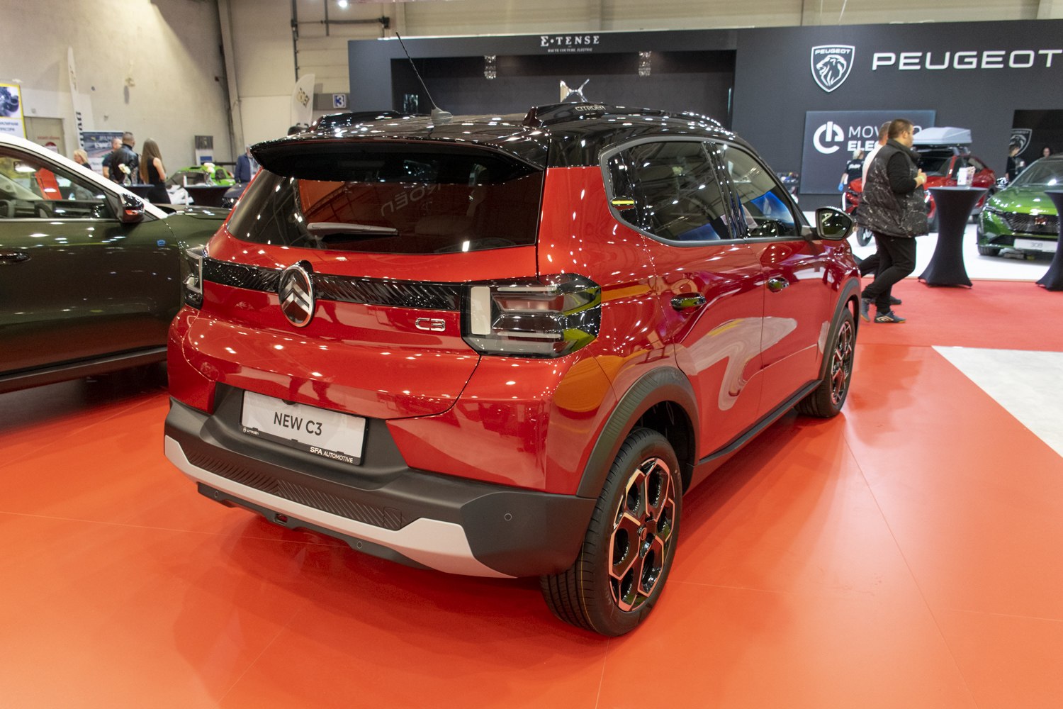 Rear view featuring distinctive taillights and black roof.
