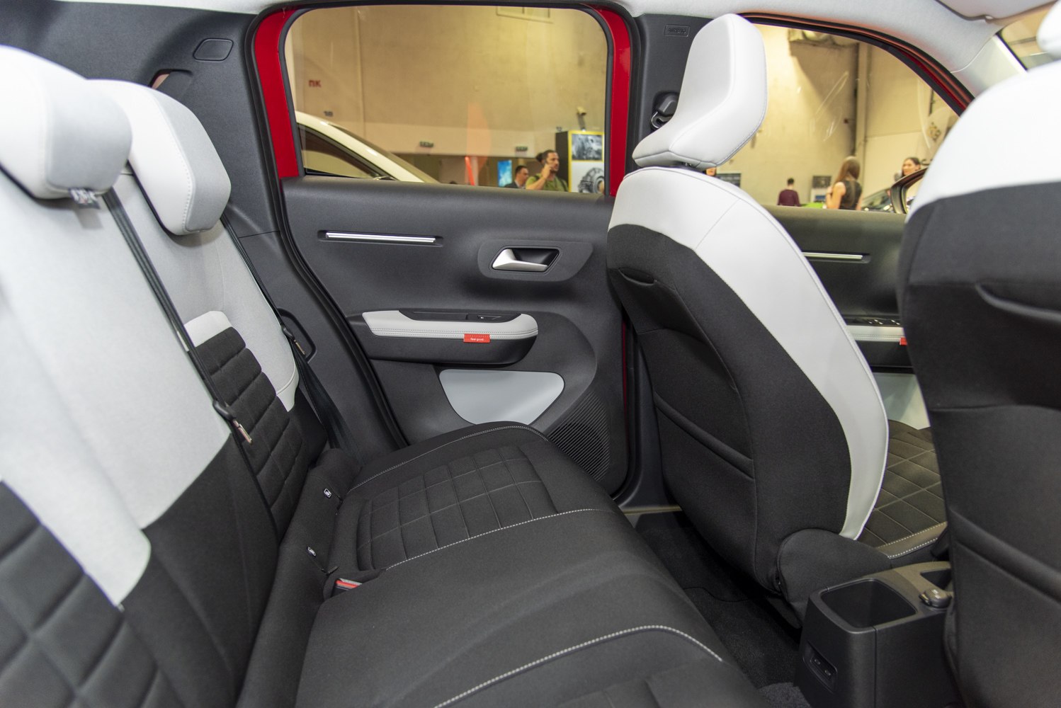 Two-tone rear seat upholstery and door panel with ergonomic design
