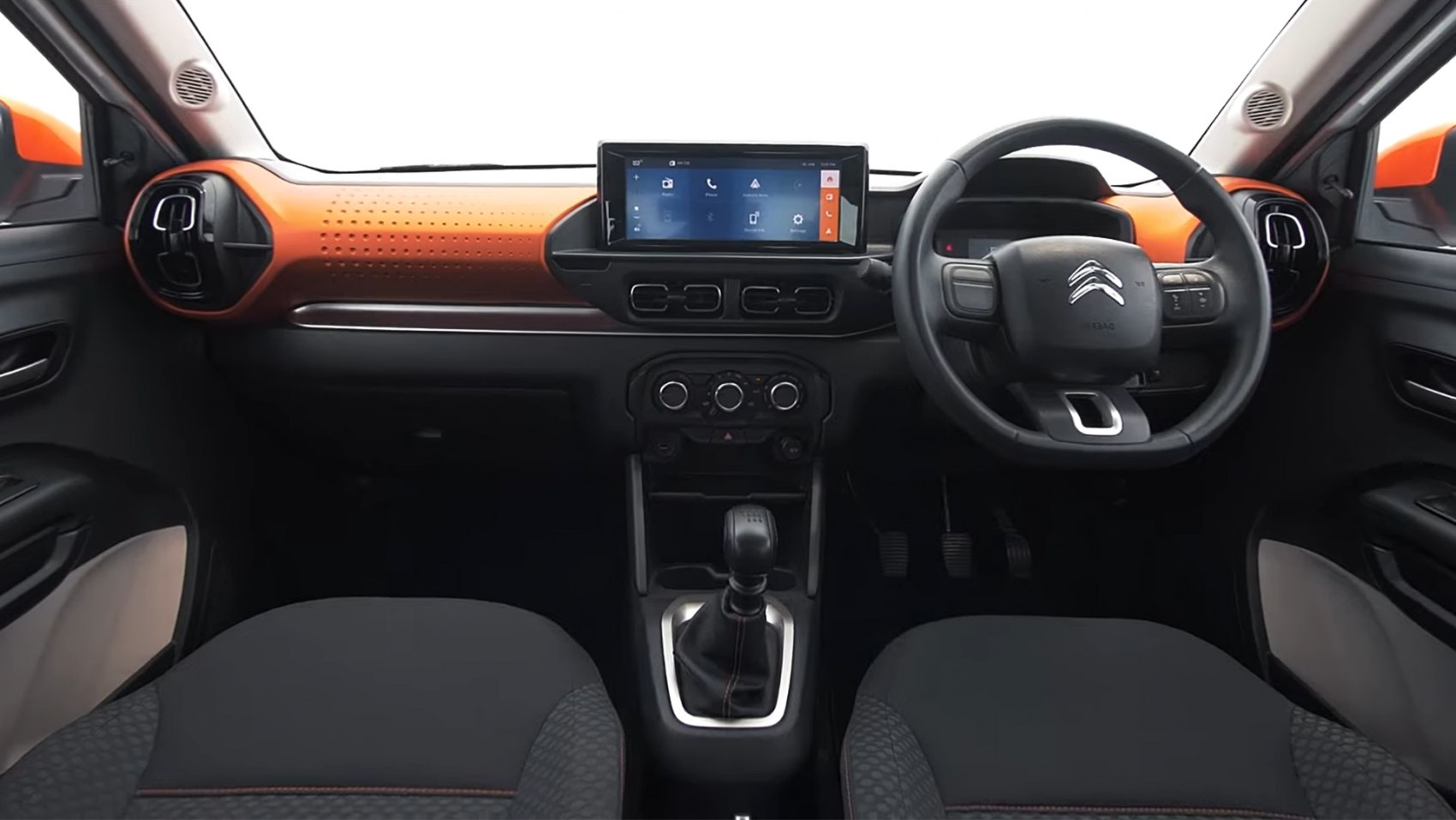Distinctive orange dashboard, touchscreen infotainment, manual gear shift