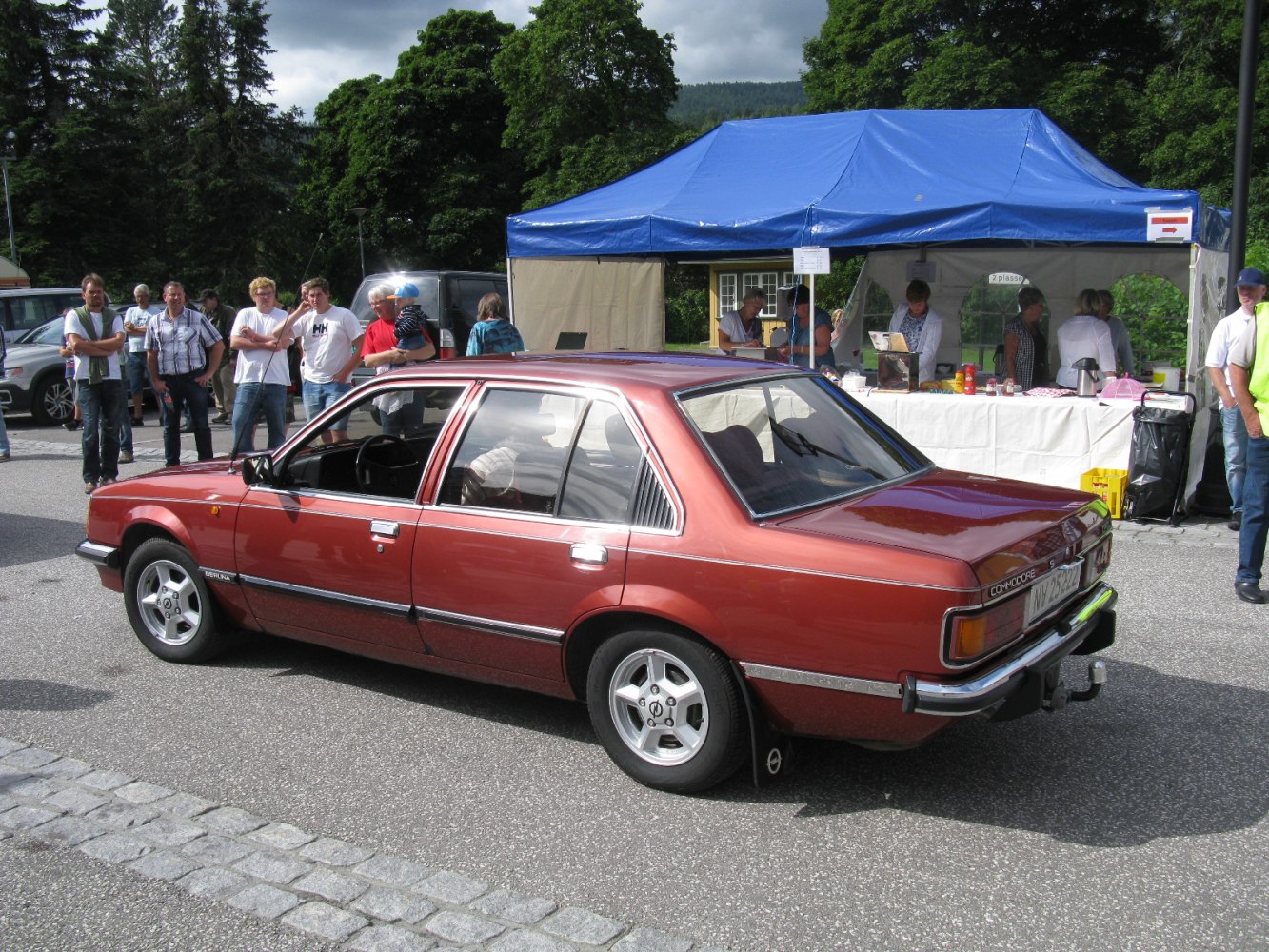 Classic four-door sedan with alloy wheels parked outdoors.