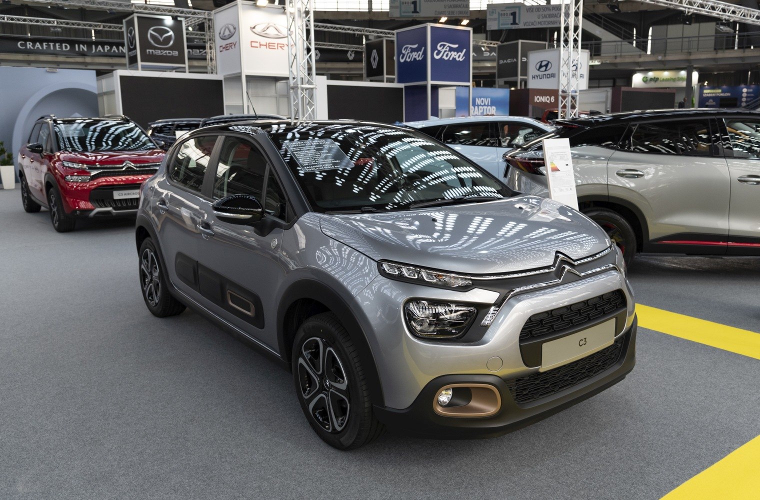 Compact hatchback with LED headlights and alloy wheels, front and side view.