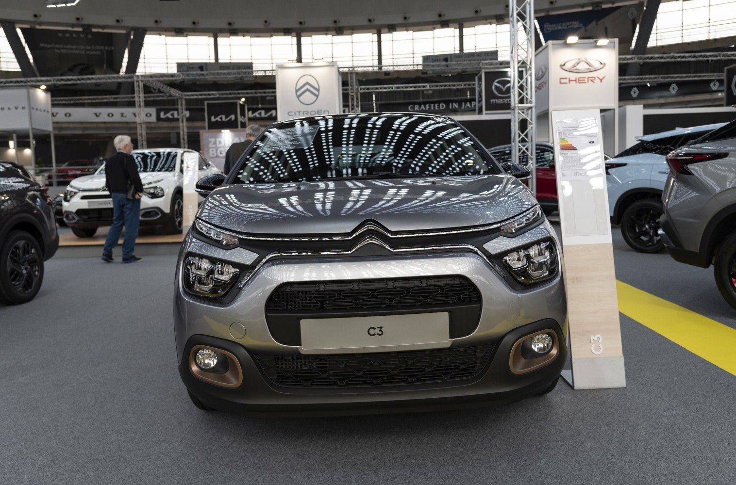 Compact hatchback front view with distinct LED headlights and unique grille.
