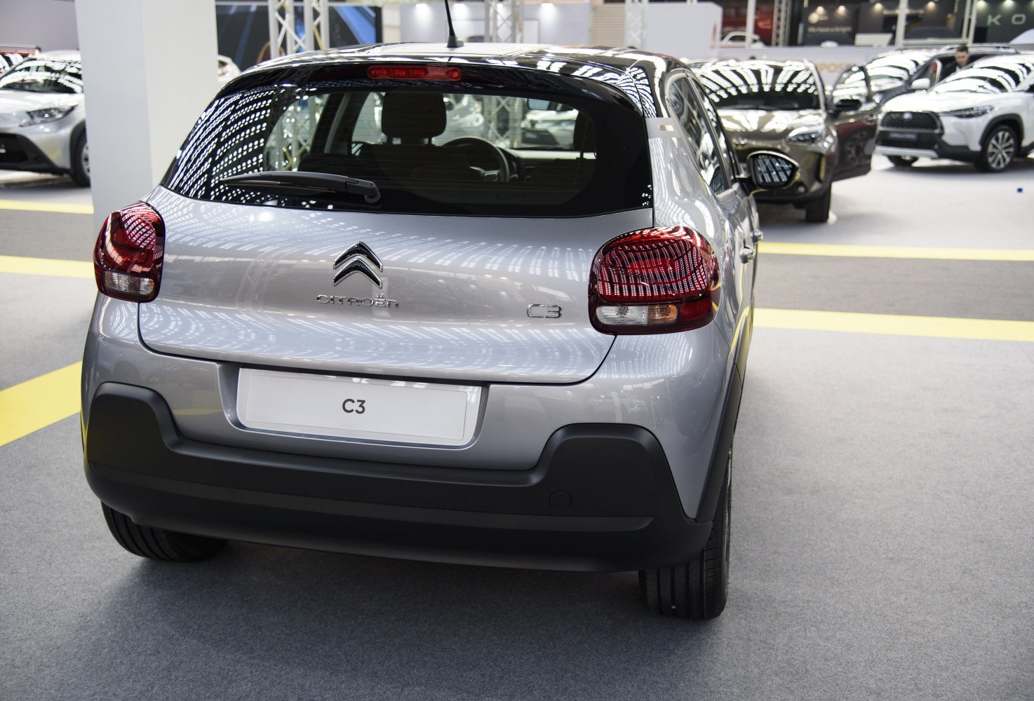 Compact hatchback rear with distinctive taillights and rear windshield wiper.