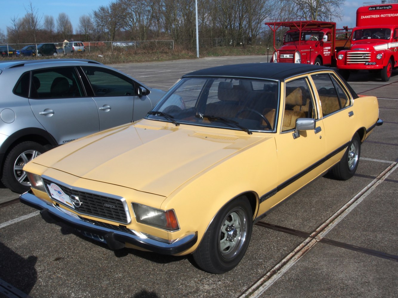 Vintage yellow sedan with vinyl roof and classic chrome details