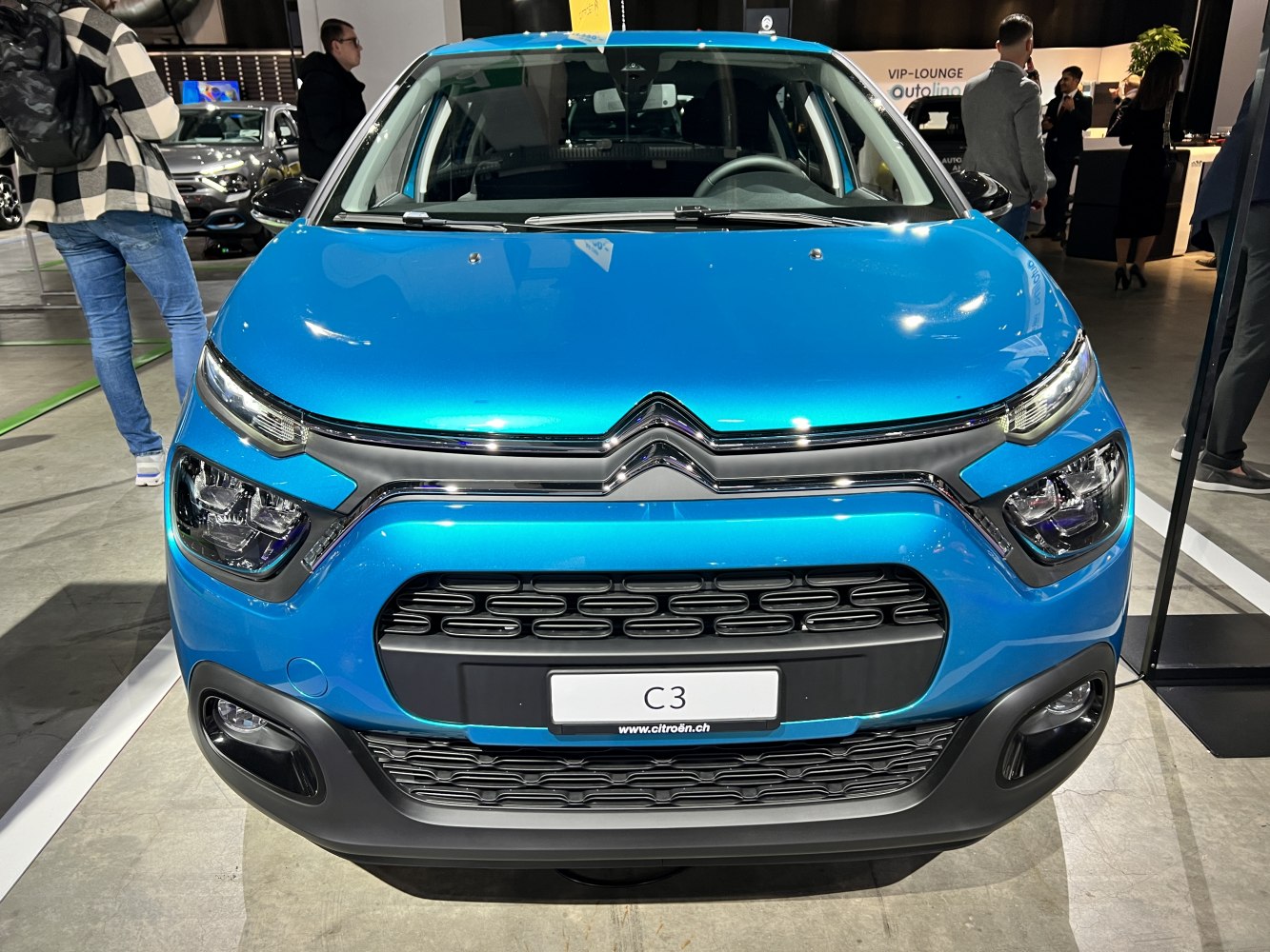 Front view with grille, headlights, and bumper in blue