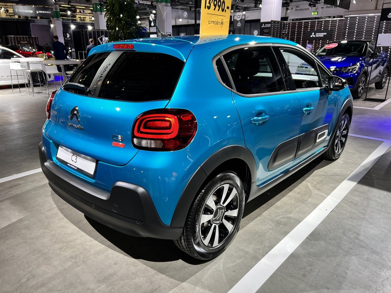 Rear and side view highlighting distinctive rear lights and protective side panels