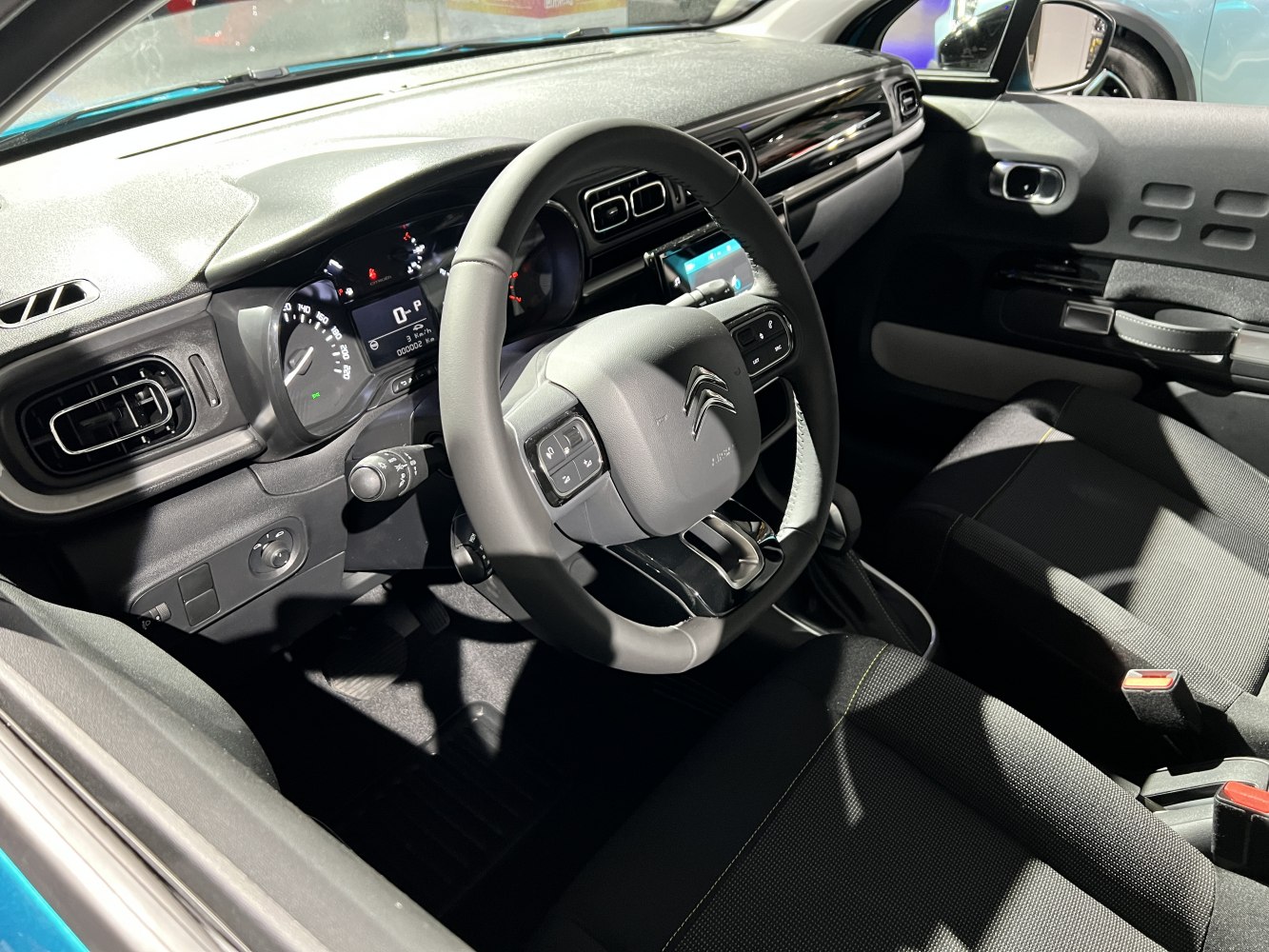 Car interior featuring dashboard, steering wheel, and central controls