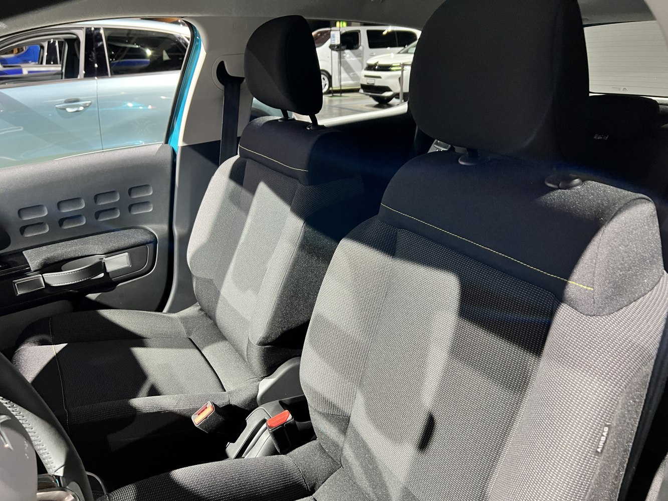 Front seats and door panel upholstery with headrests and seat belts