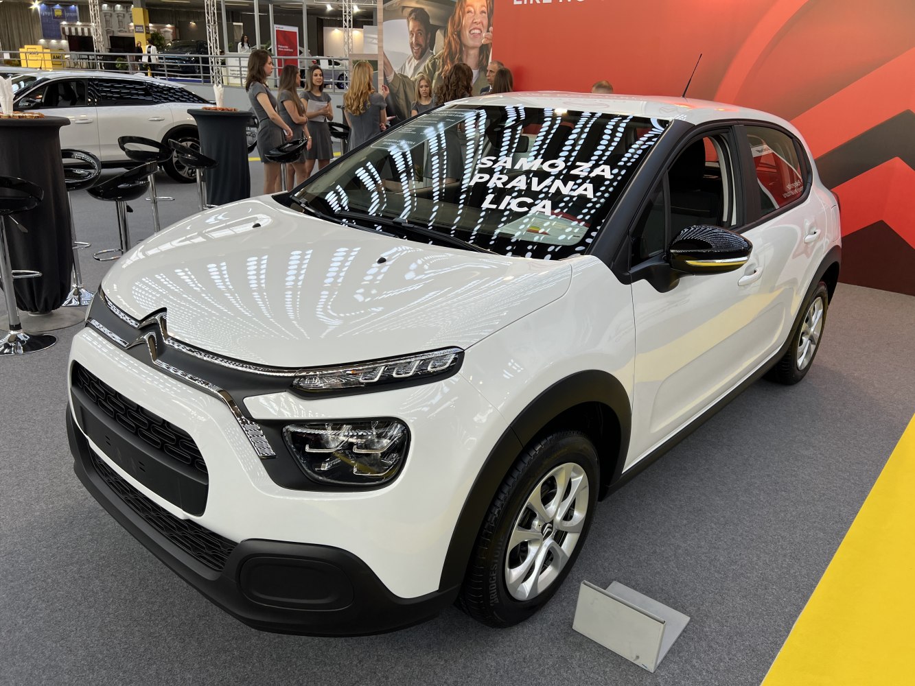 White compact crossover with split LED headlights and black trim