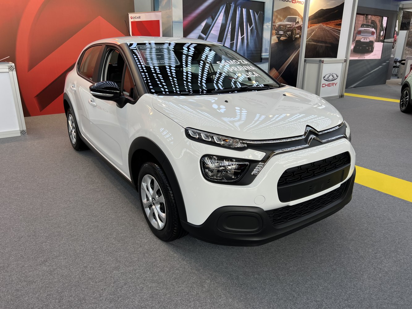 White hatchback with modern headlights and black grille