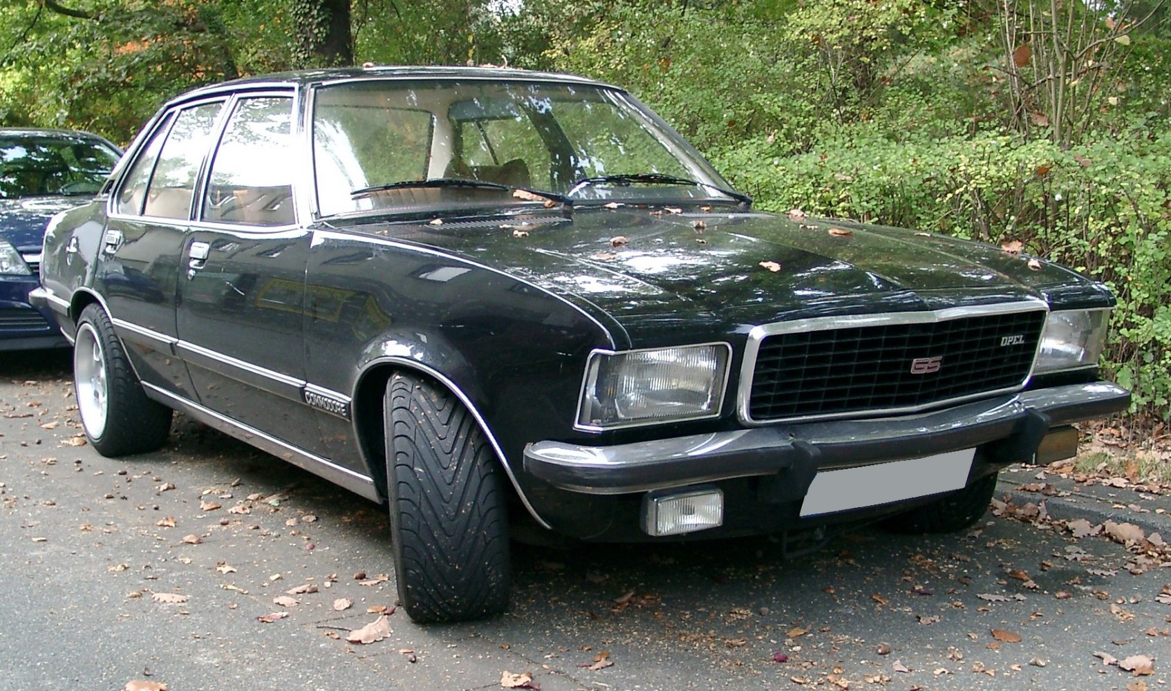 1970s sedan with square headlights, chrome trim, and front grille with fog lights