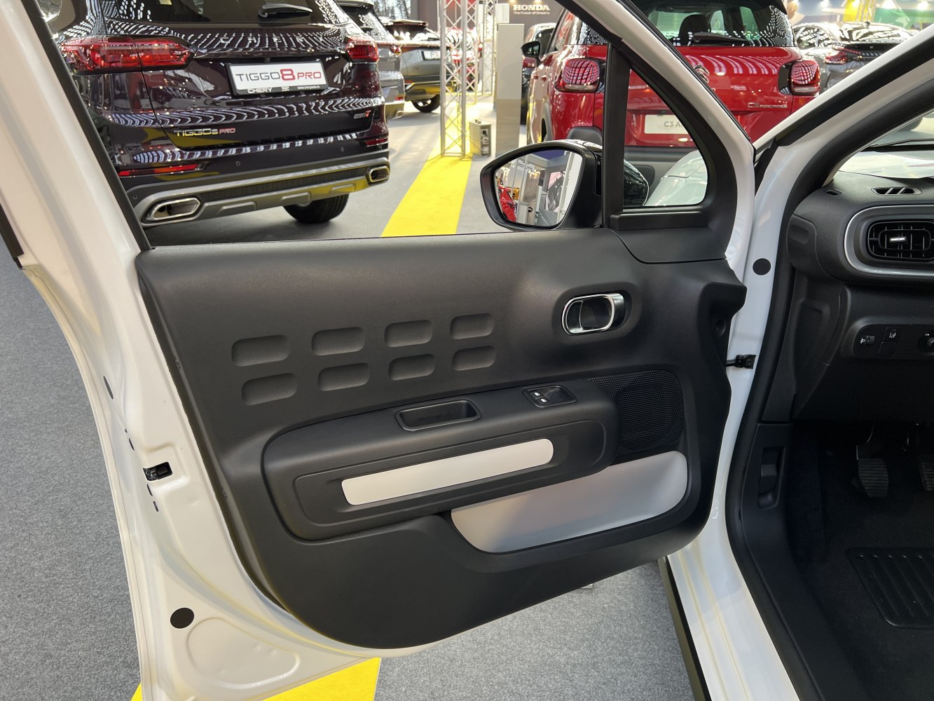 Black interior door panel with textured pattern and window controls