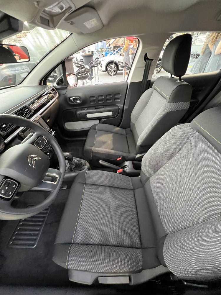 Front seats upholstery and dashboard layout with steering wheel and controls