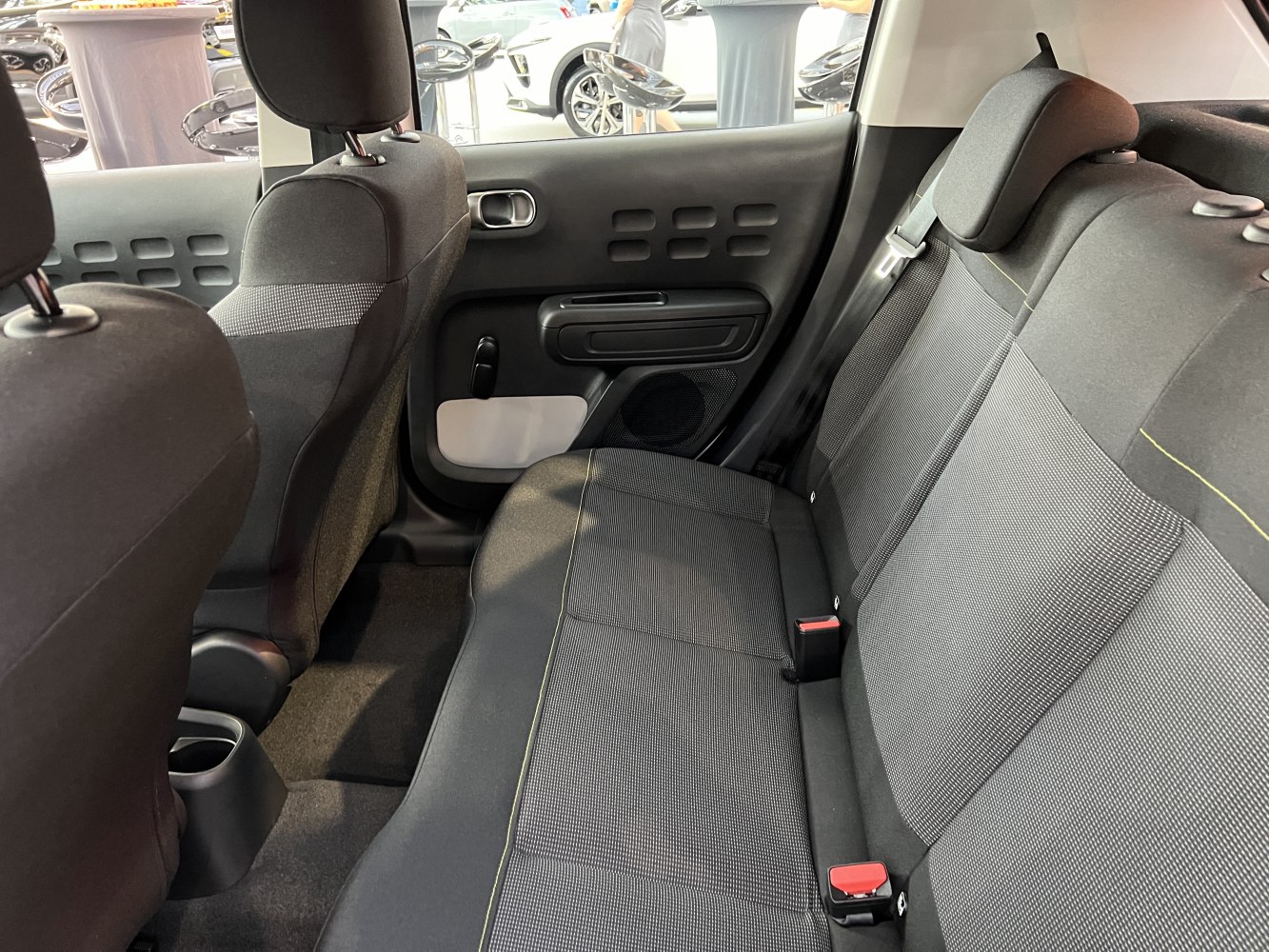 Rear seating and interior door design with fabric upholstery and ergonomic features