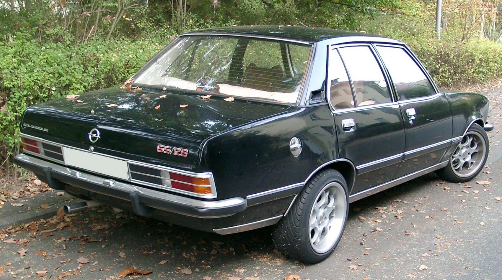 Black 1970s four-door sedan with chrome trim and GS 2.8 rear emblem