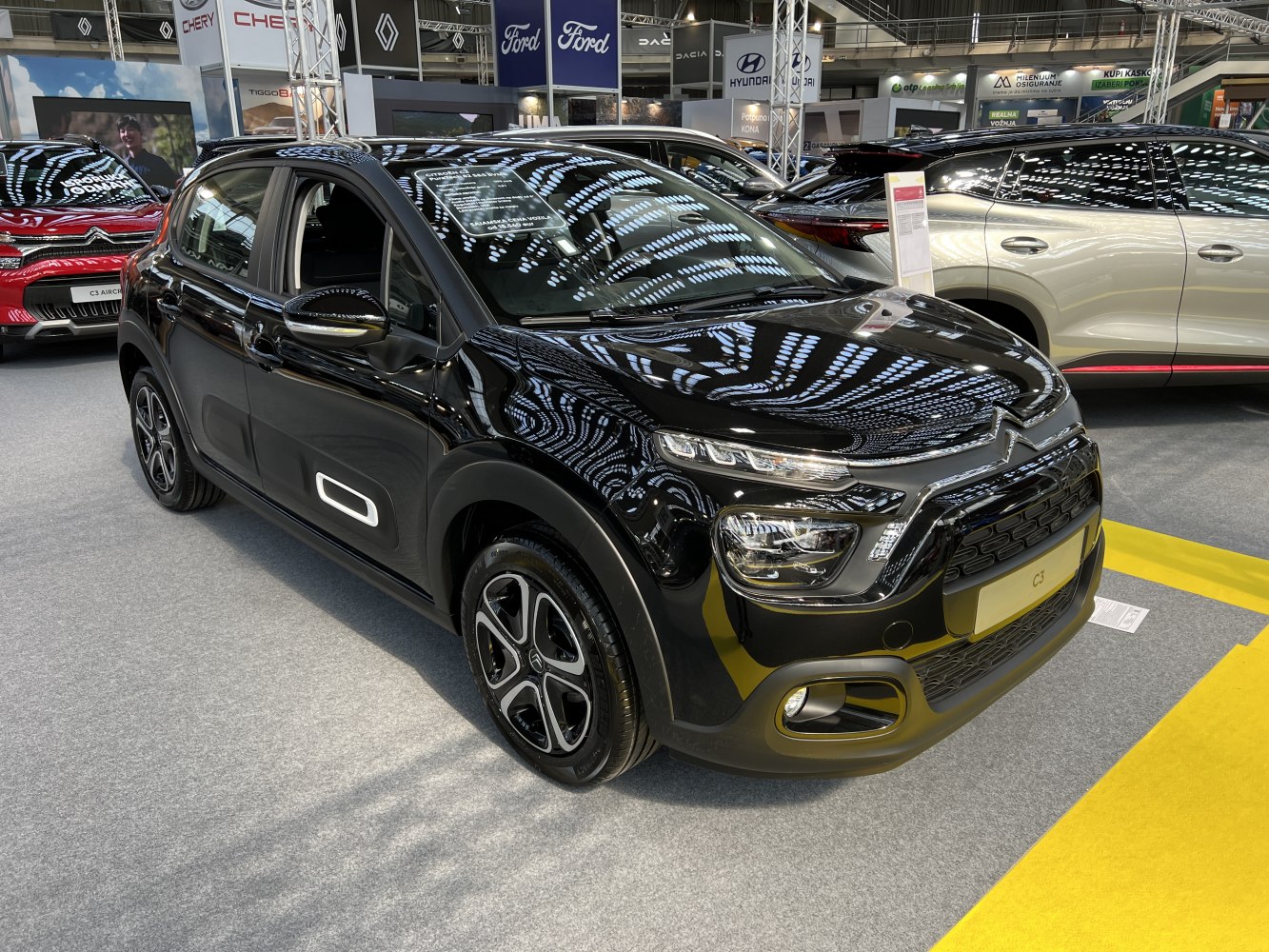 Black compact hatchback with modern LED headlights and unique side panel accents