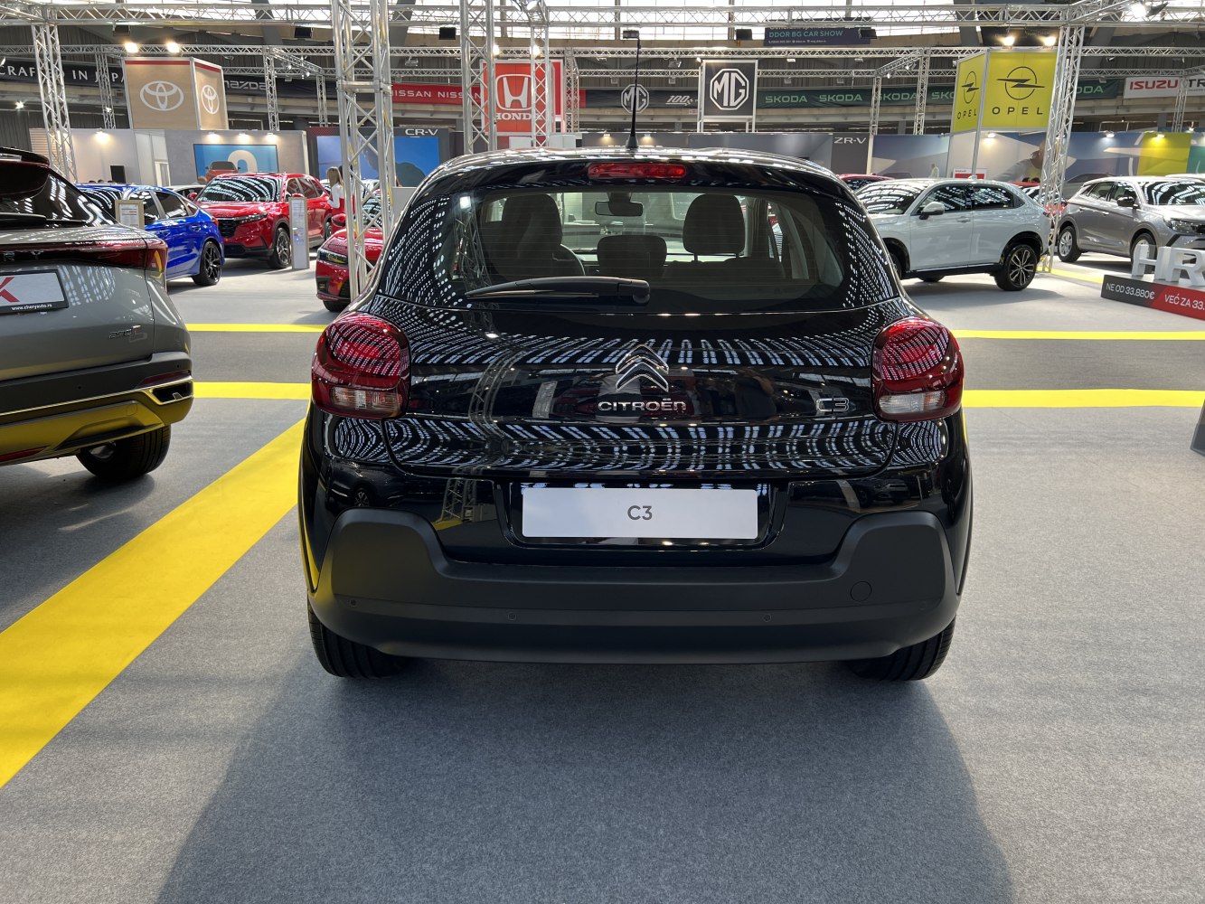 Rear view of a black hatchback with distinct taillights and rear window wiper.