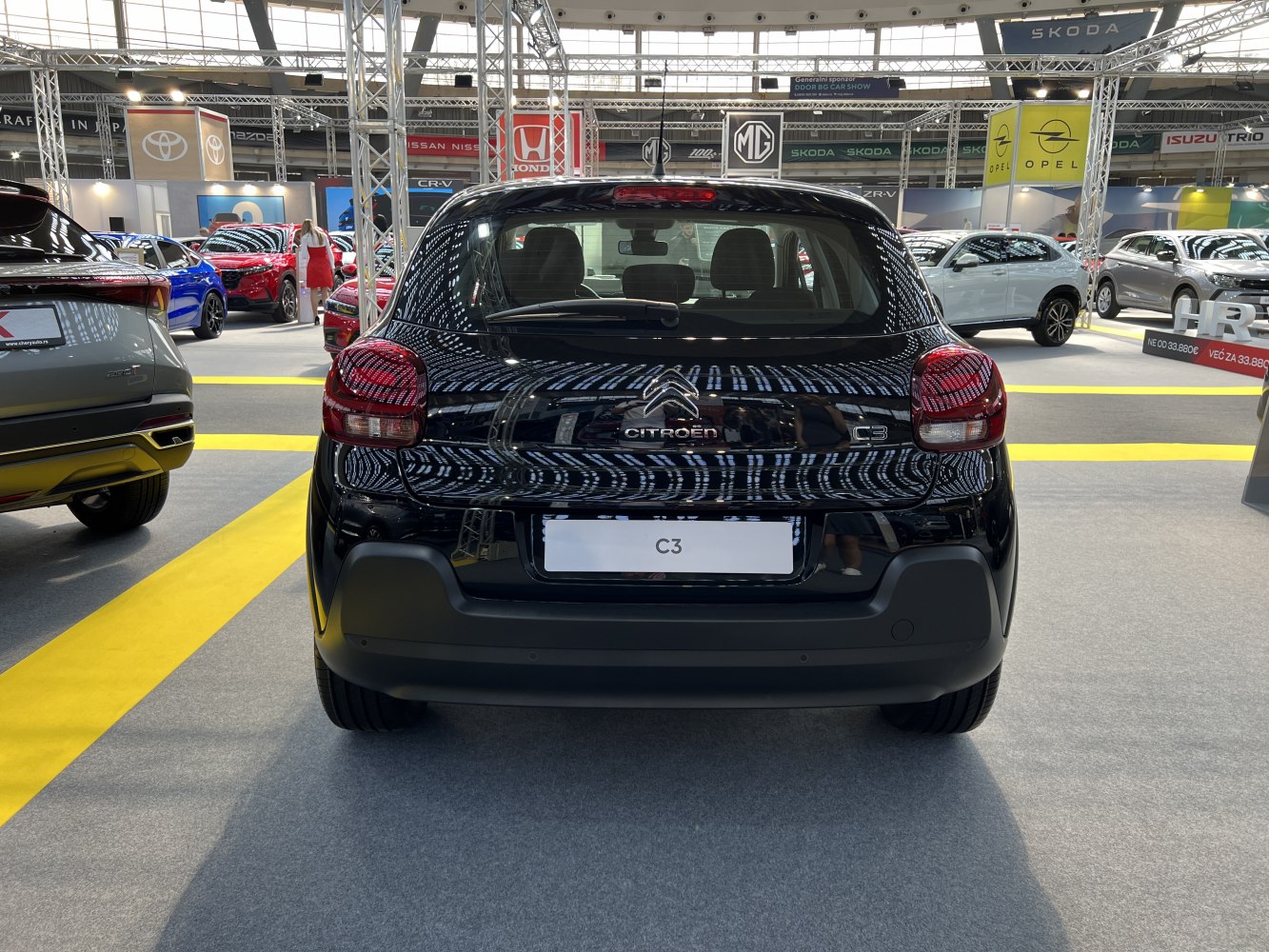 Rear view of a black hatchback with distinct taillights and rear window wiper.