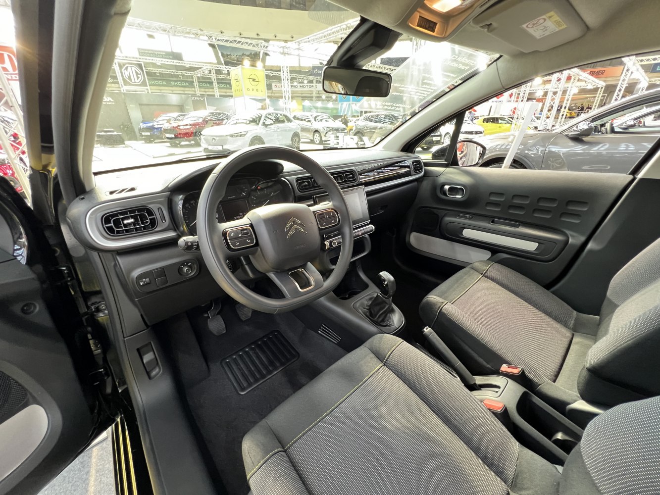 Dashboard with multi-function steering wheel and central touchscreen display