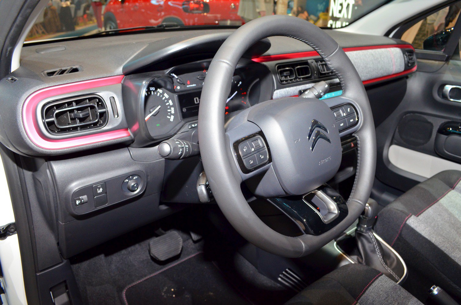 Steering wheel, dashboard, and air vents in a modern car interior