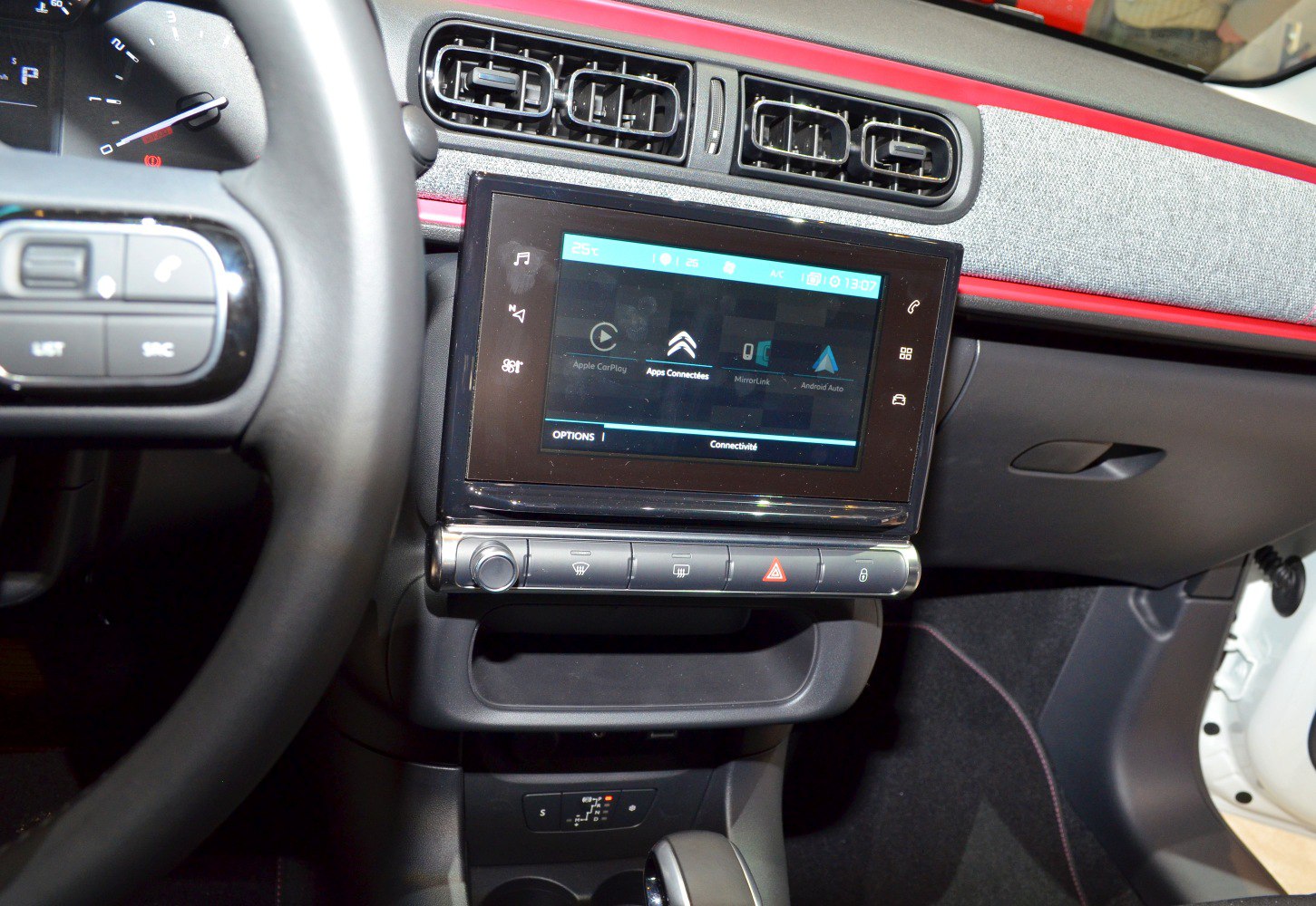 Touchscreen infotainment and dashboard panel with air vents in car interior
