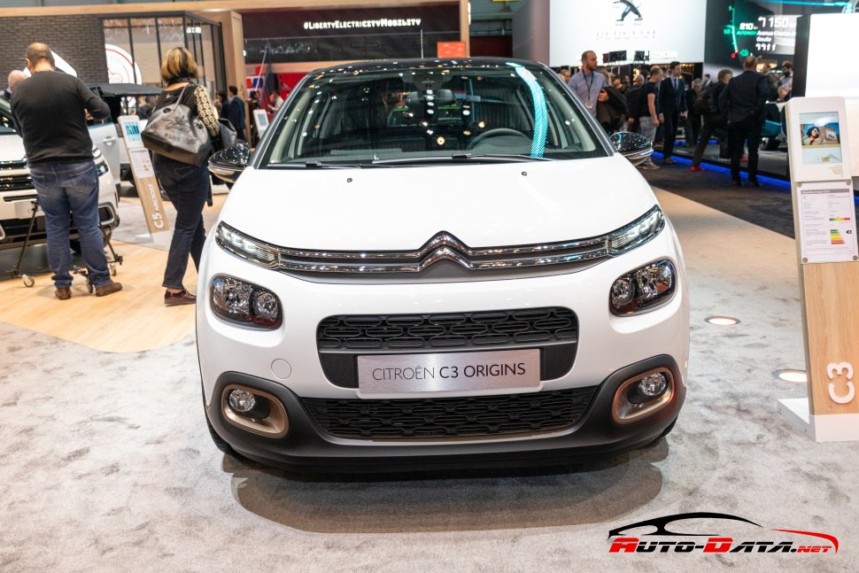 Front view of compact hatchback with signature headlights and grille