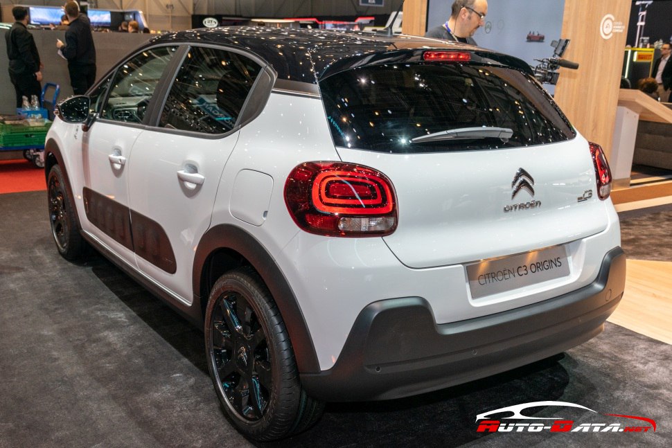 Rear view with signature tail lights and two-tone black roof on white body.